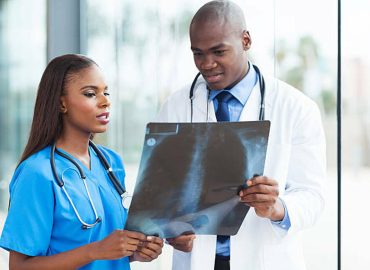 successful african american medical workers studying patient's x-ray successful african american medical workers studying patient's x-ray
